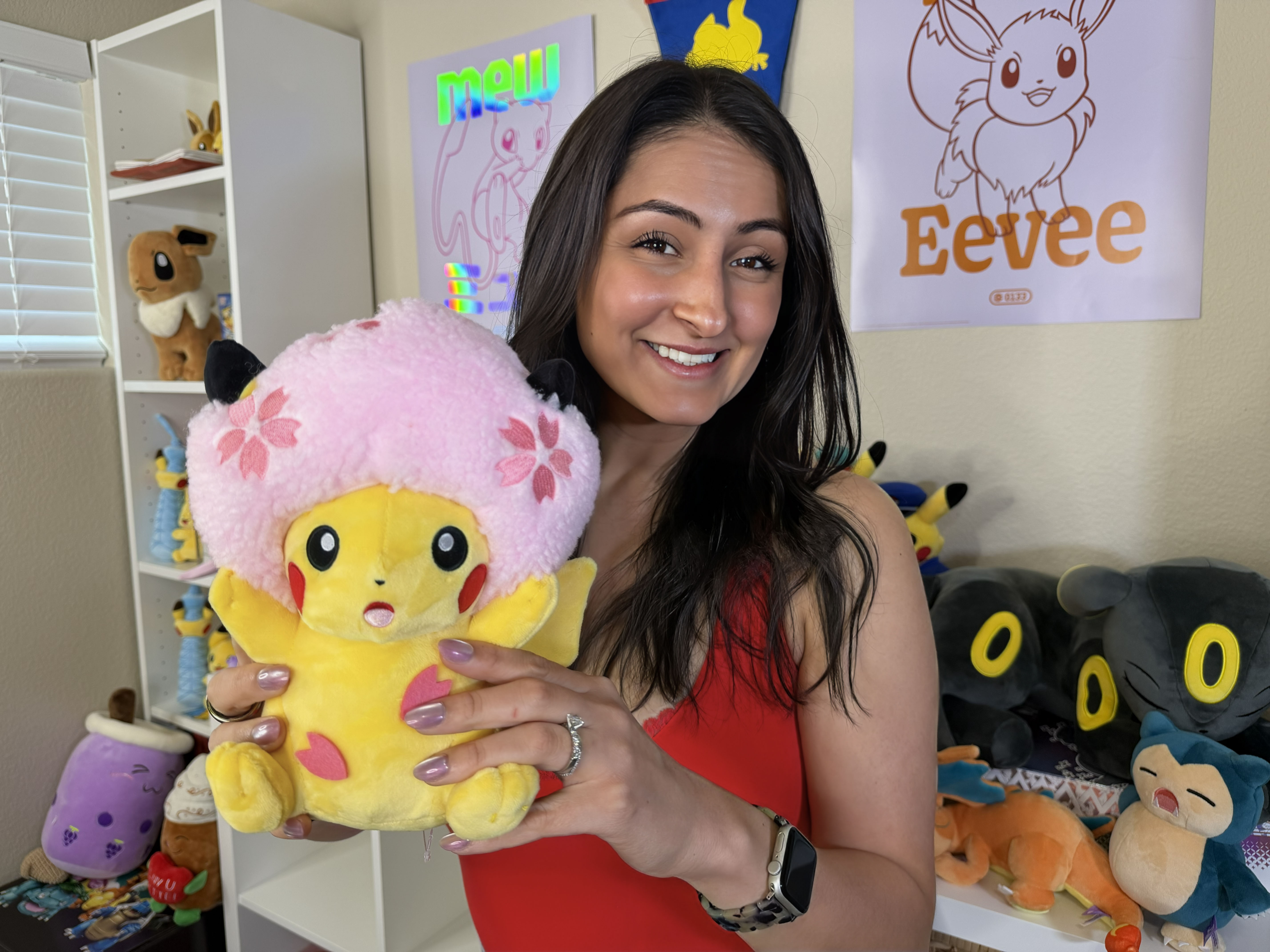CozyKat holding a Pikachu plush
