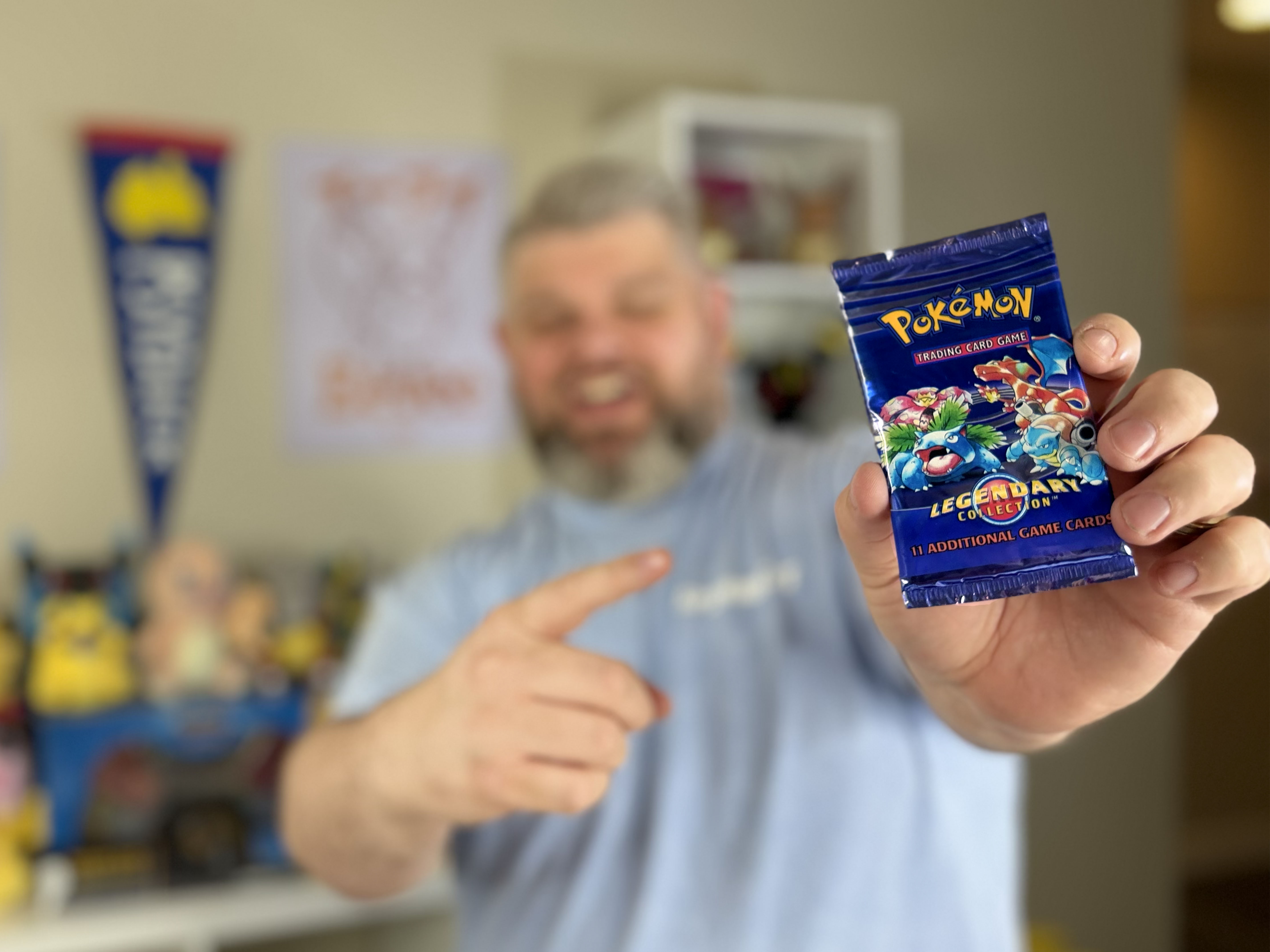 Jackpot Jonny holding a Pokémon Legendary Collection booster pack